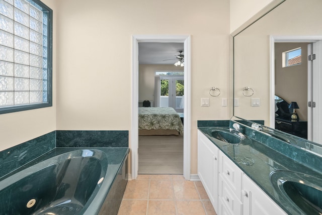 94 Terra Cotta Way, Destin, FL 32541 - ensuite bathroom with french doors, double vanity, a jetted tub, and healthy amount of natural light