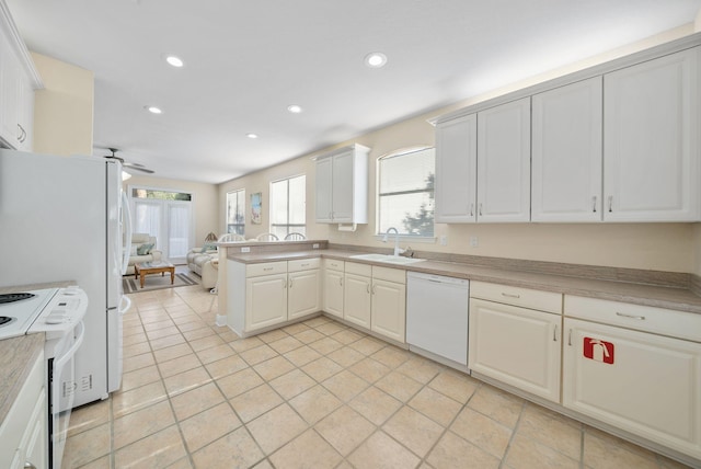94 Terra Cotta Way, Destin, FL 32541 - kitchen featuring white appliances, healthy amount of natural light, a peninsula, recessed lighting, and light tile patterned flooring