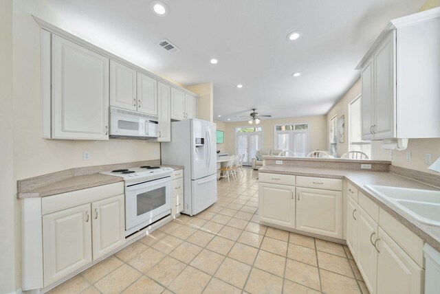94 Terra Cotta Way, Destin, FL 32541 - kitchen with white appliances, recessed lighting, ceiling fan, light countertops, and a peninsula