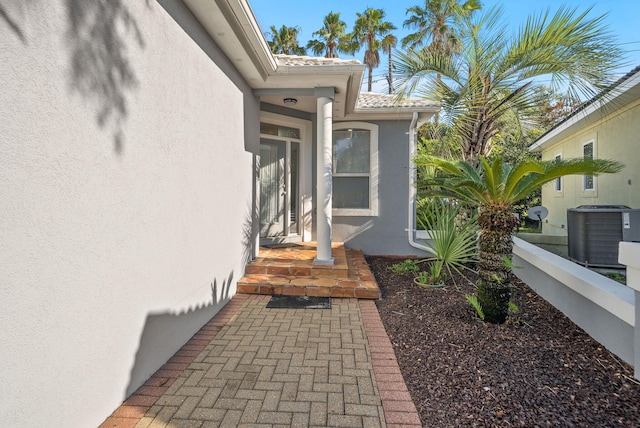 94 Terra Cotta Way, Destin, FL 32541 - doorway to property featuring stucco siding and a tiled roof