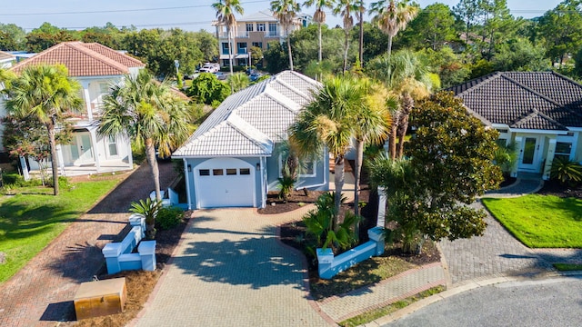 94 Terra Cotta Way, Destin, FL 32541 - mediterranean / spanish house featuring a tiled roof, decorative driveway, an attached garage, and stucco siding