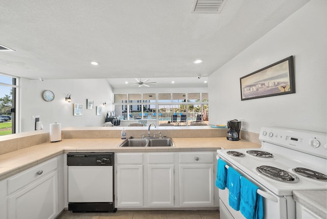 94 Terra Cotta Way, Destin, FL 32541 - kitchen featuring white appliances, white cabinetry, recessed lighting, a peninsula, and light countertops
