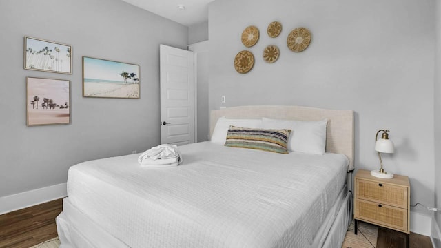 28 W Queen Palm Dr, Inlet Beach, FL 32461 - bedroom featuring baseboards and wood finished floors