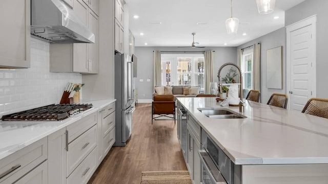28 W Queen Palm Dr, Inlet Beach, FL 32461 - kitchen with ventilation hood, stainless steel appliances, an island with sink, dark wood-style floors, and open floor plan