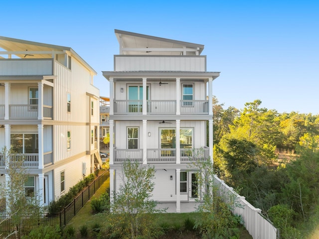 28 W Queen Palm Dr, Inlet Beach, FL 32461 - view of front facade featuring a balcony, a ceiling fan, a fenced backyard, and a patio