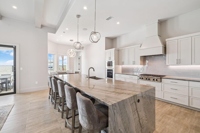31 Driftwood Ct, Santa Rosa Beach, FL 32459 - kitchen featuring premium range hood, tasteful backsplash, stainless steel gas stovetop, a large island with sink, and recessed lighting