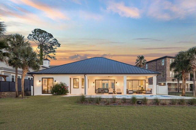 31 Driftwood Ct, Santa Rosa Beach, FL 32459 - back of house at dusk featuring a metal roof, an outdoor hangout area, stucco siding, and a ceiling fan