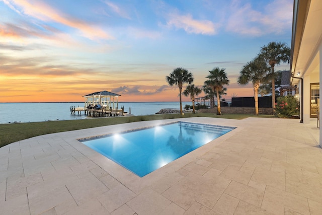 31 Driftwood Ct, Santa Rosa Beach, FL 32459 - pool at dusk with a water view, a patio, and an outdoor pool