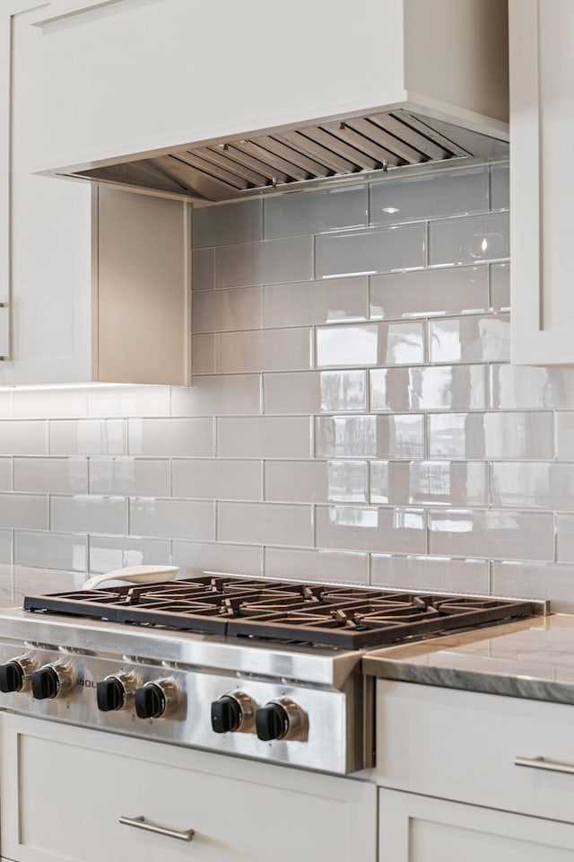 31 Driftwood Ct, Santa Rosa Beach, FL 32459 - kitchen with stainless steel gas cooktop, custom exhaust hood, white cabinets, and tasteful backsplash