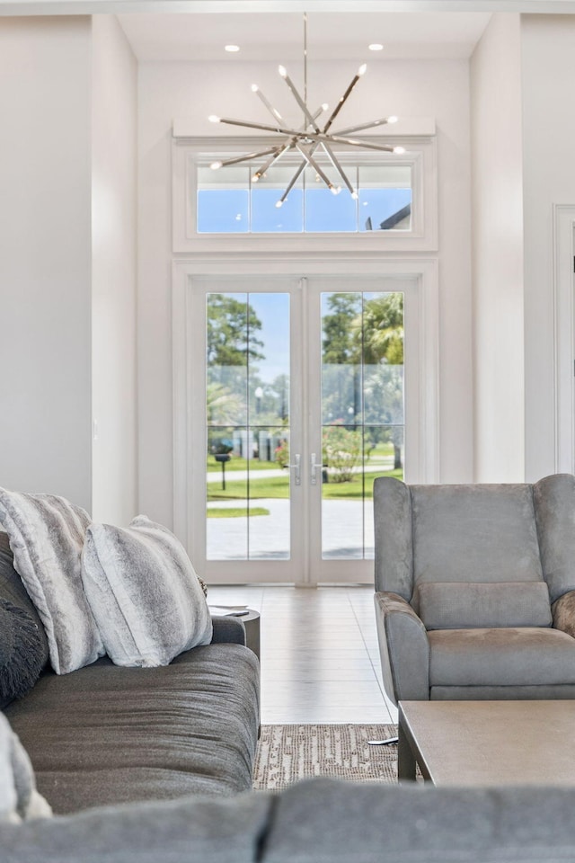 31 Driftwood Ct, Santa Rosa Beach, FL 32459 - living room featuring a chandelier, wood finished floors, french doors, a towering ceiling, and recessed lighting