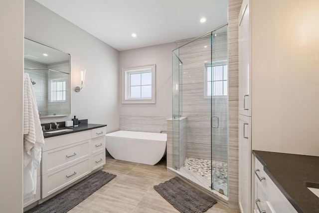 31 Driftwood Ct, Santa Rosa Beach, FL 32459 - bathroom with vanity, a stall shower, a freestanding bath, recessed lighting, and tile patterned flooring