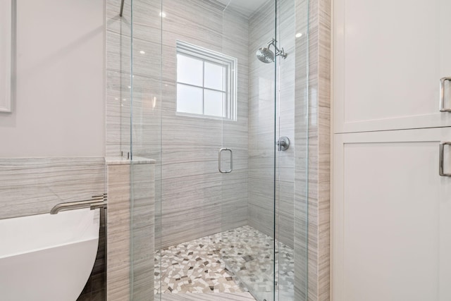 31 Driftwood Ct, Santa Rosa Beach, FL 32459 - bathroom with a freestanding bath, a shower stall, and tile walls