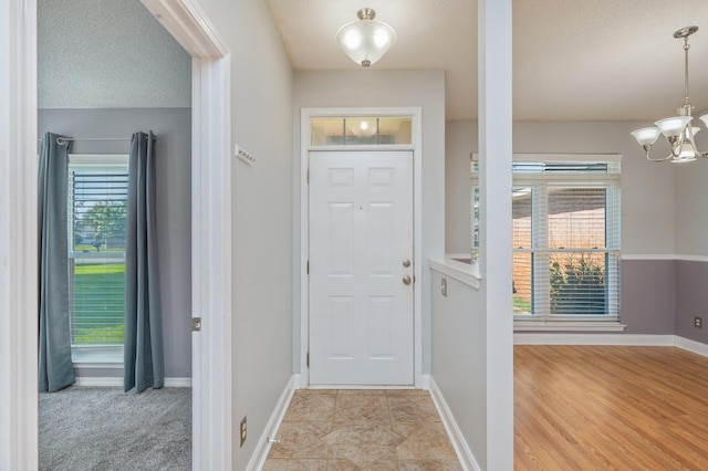 8562 Vehlin Ct, Navarre, FL 32566 - entryway featuring a chandelier and a textured ceiling