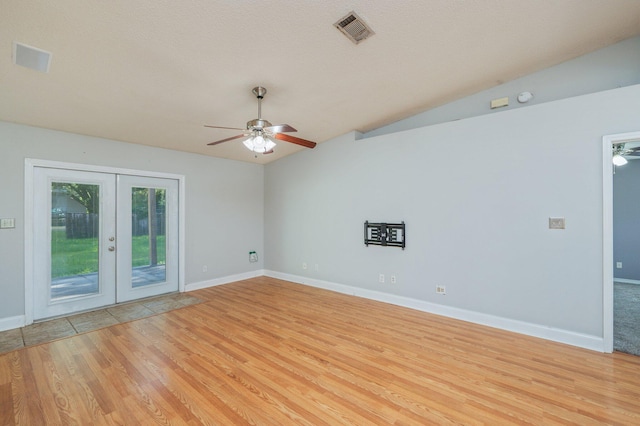8562 Vehlin Ct, Navarre, FL 32566 - empty room with a ceiling fan, french doors, light wood finished floors, and vaulted ceiling