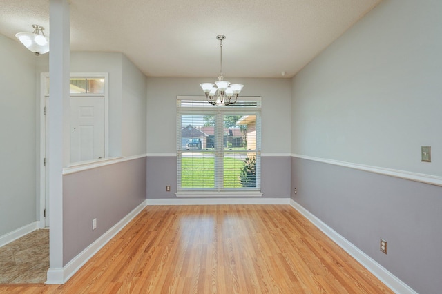 8562 Vehlin Ct, Navarre, FL 32566 - unfurnished dining area featuring a chandelier and wood finished floors