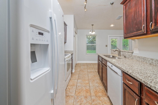 8562 Vehlin Ct, Navarre, FL 32566 - kitchen with white appliances, light stone countertops, light tile patterned floors, hanging light fixtures, and a textured ceiling