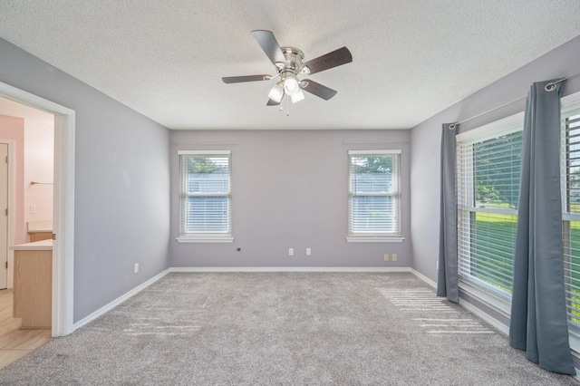 8562 Vehlin Ct, Navarre, FL 32566 - spare room featuring a ceiling fan, healthy amount of natural light, light colored carpet, and a textured ceiling