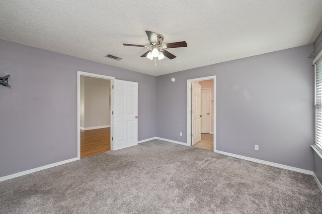 8562 Vehlin Ct, Navarre, FL 32566 - unfurnished bedroom with carpet flooring, ceiling fan, and a textured ceiling