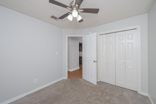 8562 Vehlin Ct, Navarre, FL 32566 - unfurnished bedroom featuring carpet floors, a closet, a textured ceiling, and ceiling fan