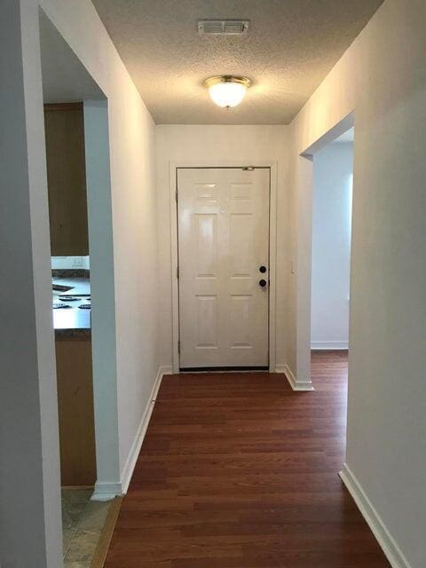 294 Limestone Cir, Crestview, FL 32539 - corridor with wood finished floors and a textured ceiling