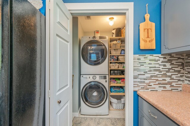 5358 Cox Ln, Crestview, FL 32539 - laundry area with estacked washer and dryer and tile patterned floors