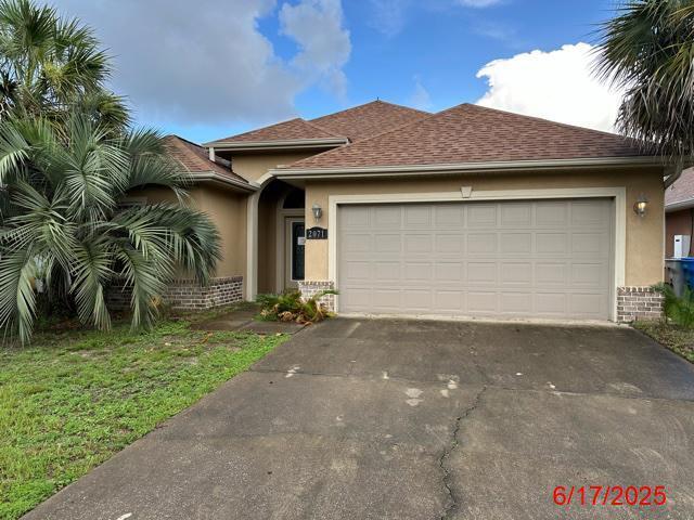 2071 Fountainview Dr, Navarre, FL 32566 - ranch-style house with stucco siding, asphalt driveway, and a garage