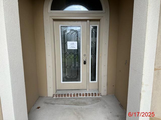 2071 Fountainview Dr, Navarre, FL 32566 - view of exterior entry with stucco siding