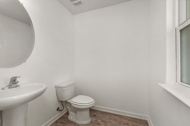 718 Widgeon Way, Crestview, FL 32539 - bathroom featuring toilet and wood finished floors