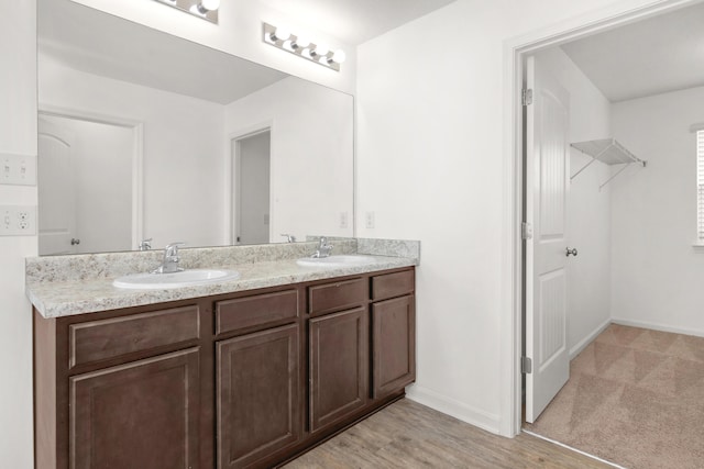 718 Widgeon Way, Crestview, FL 32539 - bathroom featuring double vanity and wood finished floors