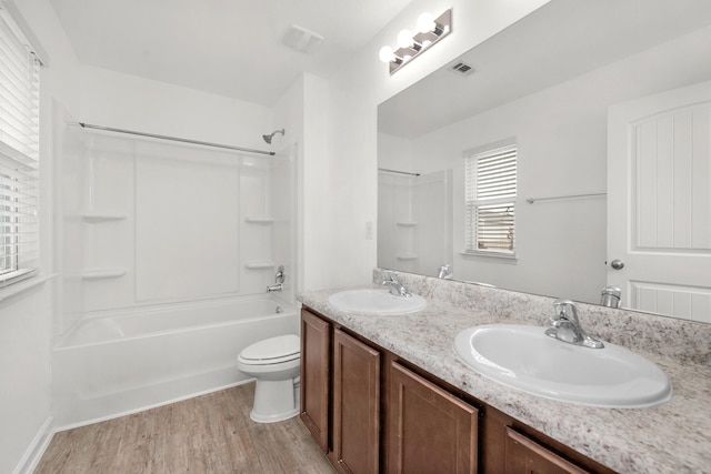 718 Widgeon Way, Crestview, FL 32539 - full bath featuring double vanity, wood finished floors, and bathtub / shower combination