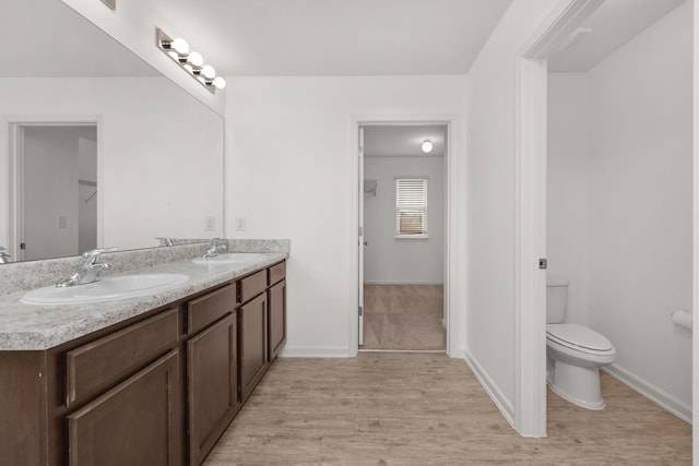 718 Widgeon Way, Crestview, FL 32539 - bathroom featuring double vanity and wood finished floors