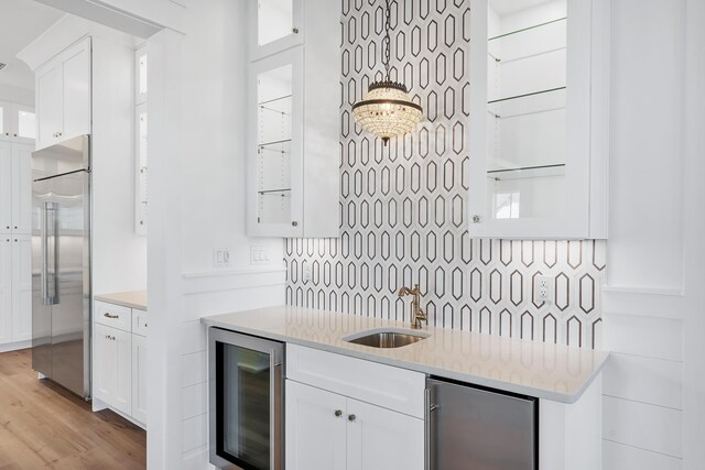 314 W Firethorn Cir Lot 33, Watersound, FL 32461 - kitchen with beverage cooler, built in refrigerator, stainless steel fridge, backsplash, and white cabinets