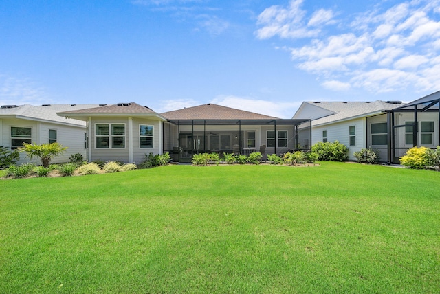 8324 Fins Up Ct, Panama City Beach, FL 32413 - rear view of property with a lawn and glass enclosure
