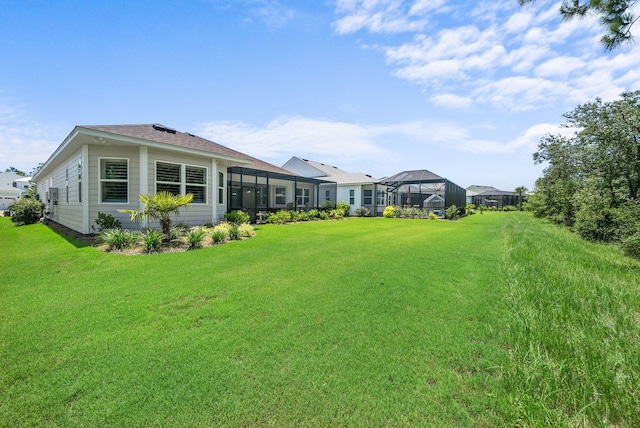 8324 Fins Up Ct, Panama City Beach, FL 32413 - view of grassy yard with glass enclosure