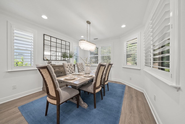 8324 Fins Up Ct, Panama City Beach, FL 32413 - dining room featuring wood finished floors, plenty of natural light, crown molding, a chandelier, and recessed lighting