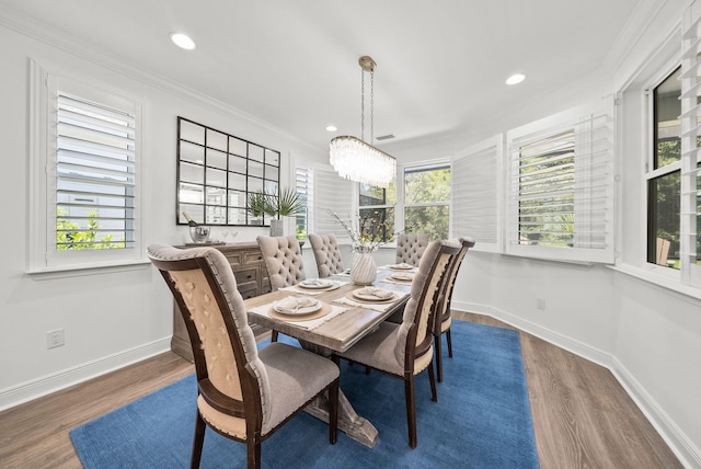 8324 Fins Up Ct, Panama City Beach, FL 32413 - dining area featuring wood finished floors, a chandelier, recessed lighting, and crown molding