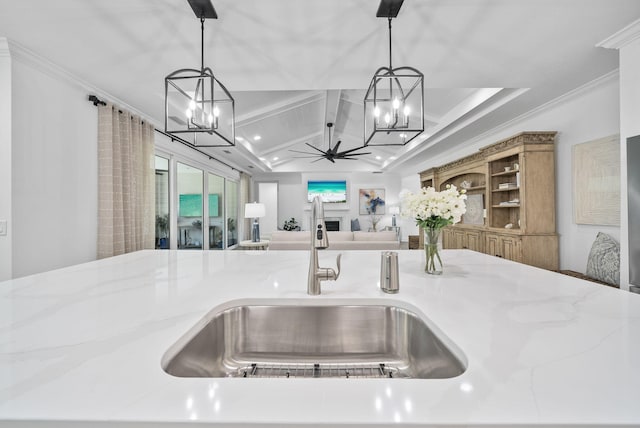 8324 Fins Up Ct, Panama City Beach, FL 32413 - kitchen view of a chandelier, crown molding, decorative light fixtures, beamed ceiling, and light stone countertops