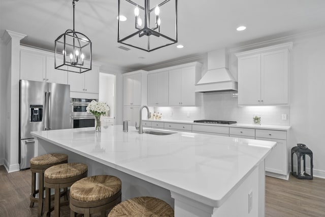 8324 Fins Up Ct, Panama City Beach, FL 32413 - kitchen featuring custom range hood, stainless steel appliances, a chandelier, wood finished floors, and white cabinetry