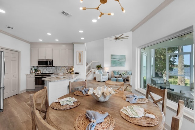 961 Northshore Dr, Miramar Beach, FL 32550 - dining area with stairs, crown molding, recessed lighting, light wood-type flooring, and a ceiling fan
