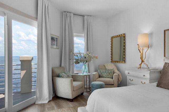 961 Northshore Dr, Miramar Beach, FL 32550 - bedroom with wood finished floors, multiple windows, and a water view
