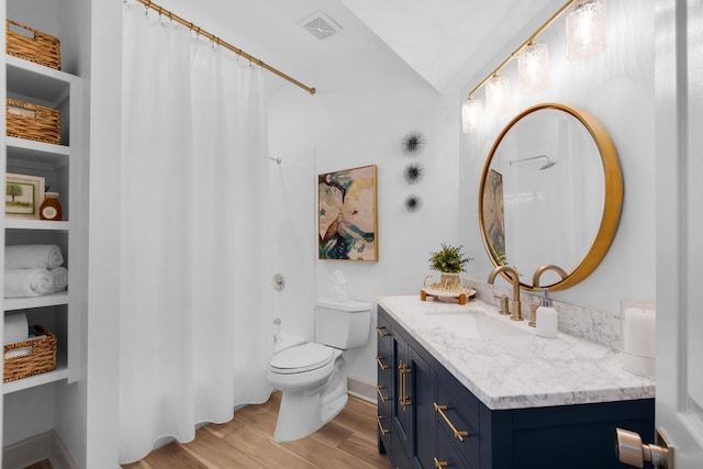 961 Northshore Dr, Miramar Beach, FL 32550 - bathroom featuring vanity, wood finished floors, vaulted ceiling, a shower with shower curtain, and built in features