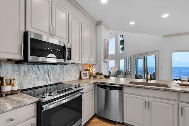 961 Northshore Dr, Miramar Beach, FL 32550 - kitchen featuring appliances with stainless steel finishes, healthy amount of natural light, decorative backsplash, white cabinetry, and recessed lighting