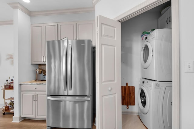 961 Northshore Dr, Miramar Beach, FL 32550 - washroom featuring stacked washer / dryer, crown molding, and light wood finished floors