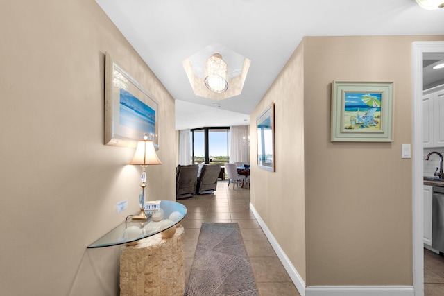 1096 Scenic Gulf Dr Unit 311, Miramar Beach, FL 32550 - hall featuring light tile patterned floors and baseboards