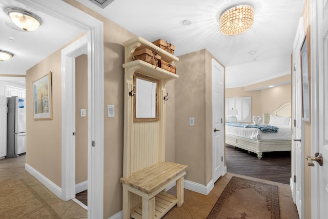 1096 Scenic Gulf Dr Unit 311, Miramar Beach, FL 32550 - mudroom featuring light tile patterned floors and a chandelier