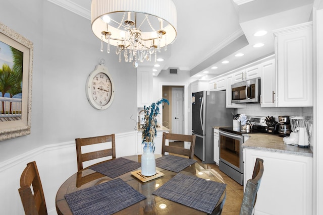 1096 Scenic Gulf Dr Unit 311, Miramar Beach, FL 32550 - dining space featuring recessed lighting, a wainscoted wall, light tile patterned flooring, ornamental molding, and a chandelier
