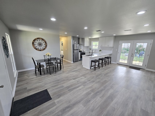 726 Clark Dr, Fort Walton Beach, FL 32547 - dining area featuring recessed lighting, light wood finished floors, and french doors