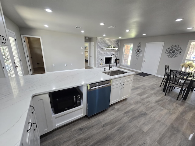 726 Clark Dr, Fort Walton Beach, FL 32547 - kitchen with dishwasher, black microwave, recessed lighting, wood finished floors, and white cabinets
