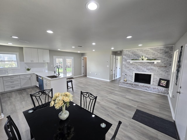726 Clark Dr, Fort Walton Beach, FL 32547 - dining room with french doors, light wood finished floors, a fireplace, and recessed lighting
