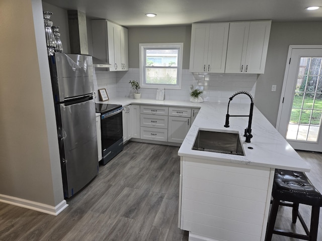 726 Clark Dr, Fort Walton Beach, FL 32547 - kitchen featuring freestanding refrigerator, electric range oven, a peninsula, light stone countertops, and dark wood-style floors